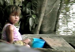 Girl in dugout, watching us.