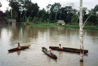 Children paddled out in their dugouts to greet us.